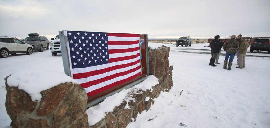 A US flag covers a sign at the entrance of the Malheur National Wildlife Refuge near Burns, Oregon, on Sunday (Reuters photo)
